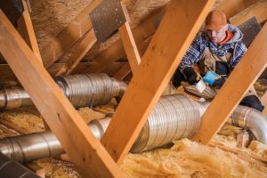 February 2 2022 - Pictured here is a insulation technician in an attic -CWR Provides Damage Repair And Insulation Replacement Services After Mice Infestations Are Resolved