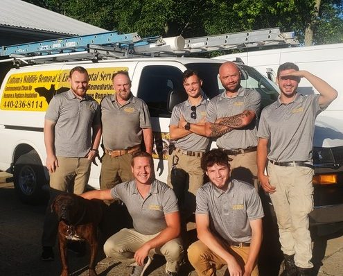 June 30 2021 - Pictured Here Are 7 Specially Trained Bat Removal Professionals From The CWR Bat Removal Service Of Ohio - Back Row, From Left To Right Are Mike Cottom Jr, Mike Cottom Sr, Alex Svensen, Jason Neitenbach and Nathan Lang. Front Row, From Left To Right Are CRW's mascot dog Hendrix, Tyler Phillips and Kyle Fortune. These professional, licensed and certified bat control experts provide humane bat removal services to Ohio homeowners and Ohio businesses that safely solve bat problems, exclude bats from attics, eliminate bat infestations and get rid of bats in attics and walls that have become pests. 